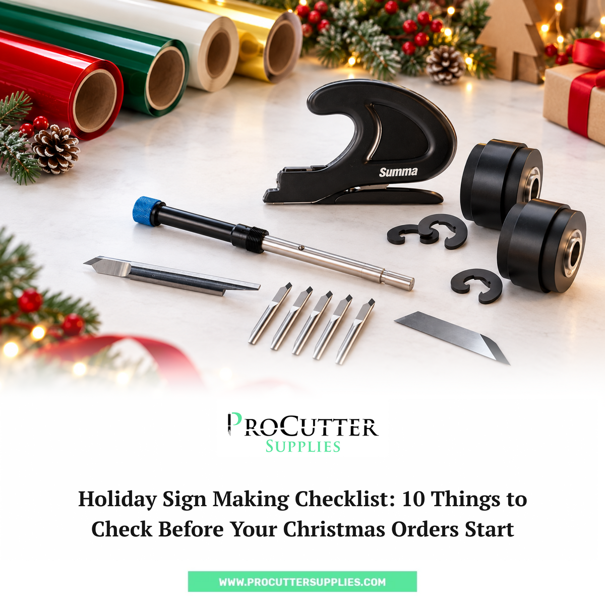 Vinyl cutter blades, a Summa tool, pinch rollers and a blade holder on a marble table with red, green, white and gold vinyl rolls and Christmas decor. ProCutter Supplies holiday sign making checklist.